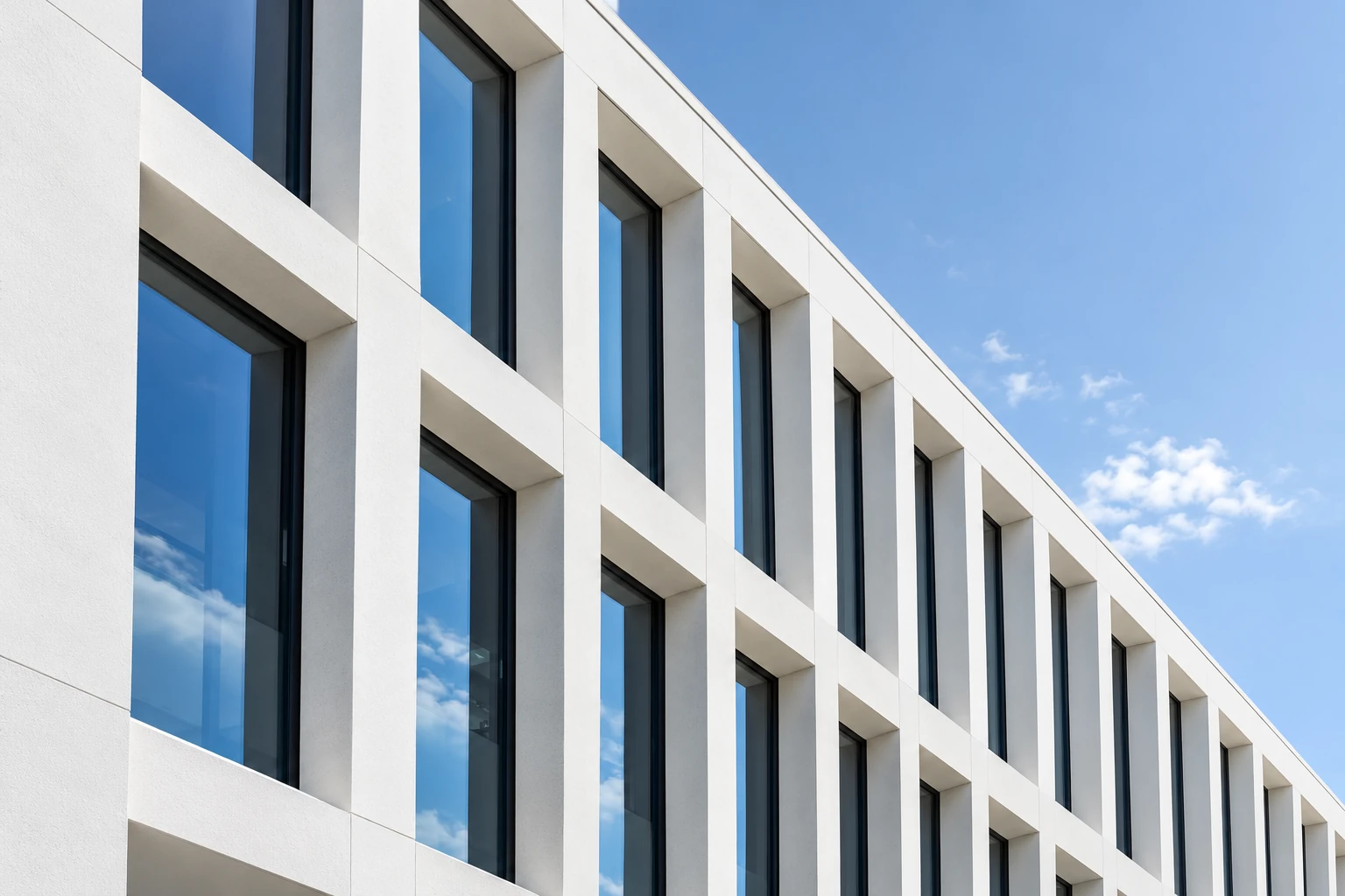 Architectural study of clean white window profiles and blue glazing